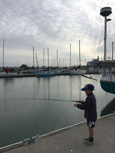 boy fishing from a pier
